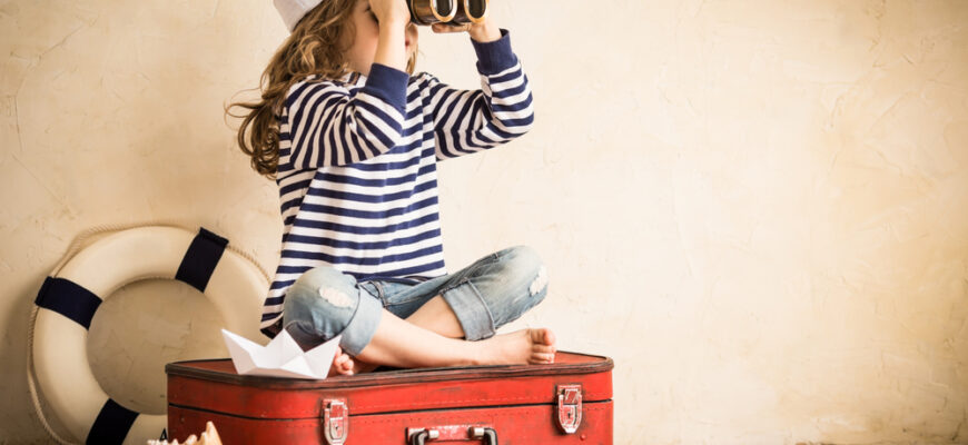 Happy,Kid,Playing,With,Toy,Sailing,Boat,Indoors.,Travel,And